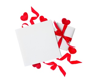 Photo of Blank card, gift box and red decorative hearts on white background, top view. Valentine's Day celebration