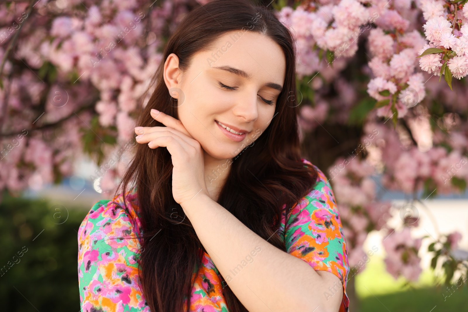 Photo of Beautiful woman near blossoming tree on spring day