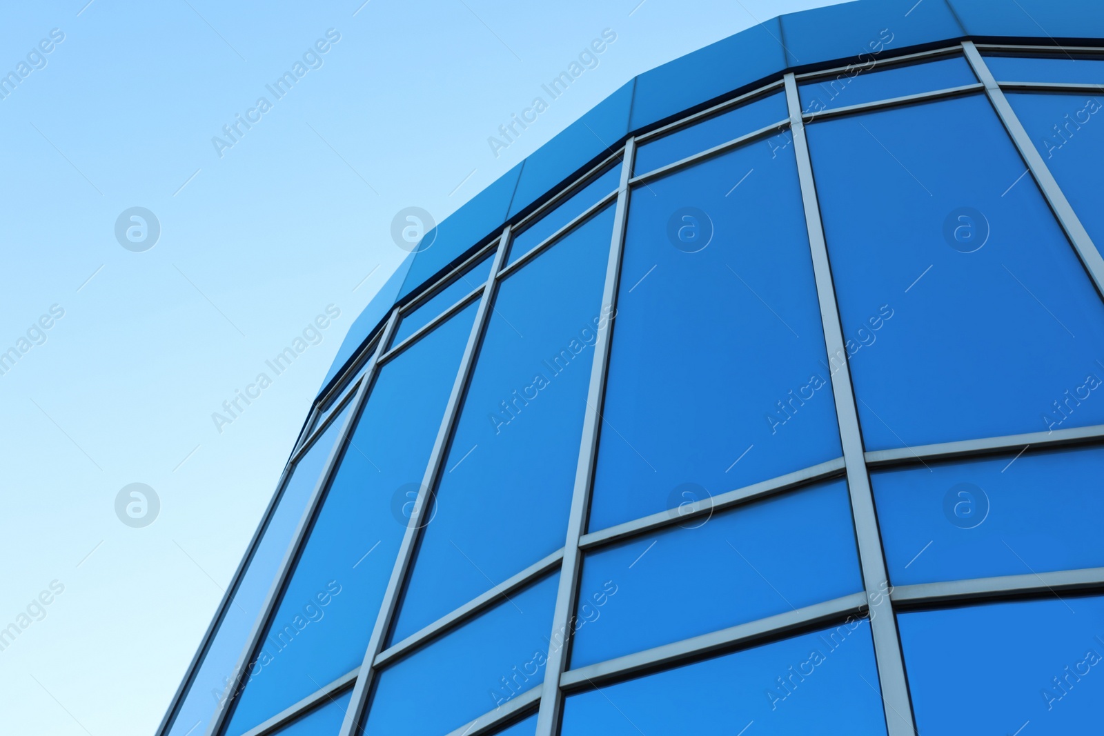 Photo of Modern building with tinted windows outdoors. low angle view