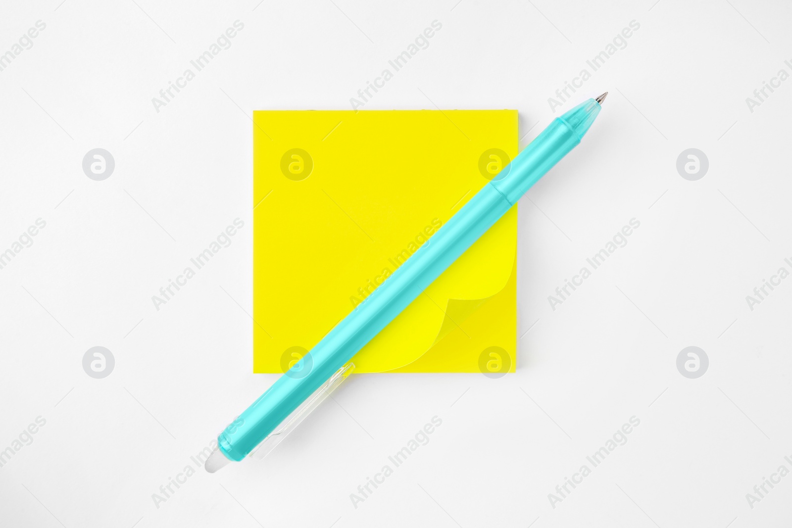 Photo of Blank paper note and pen on white background, top view