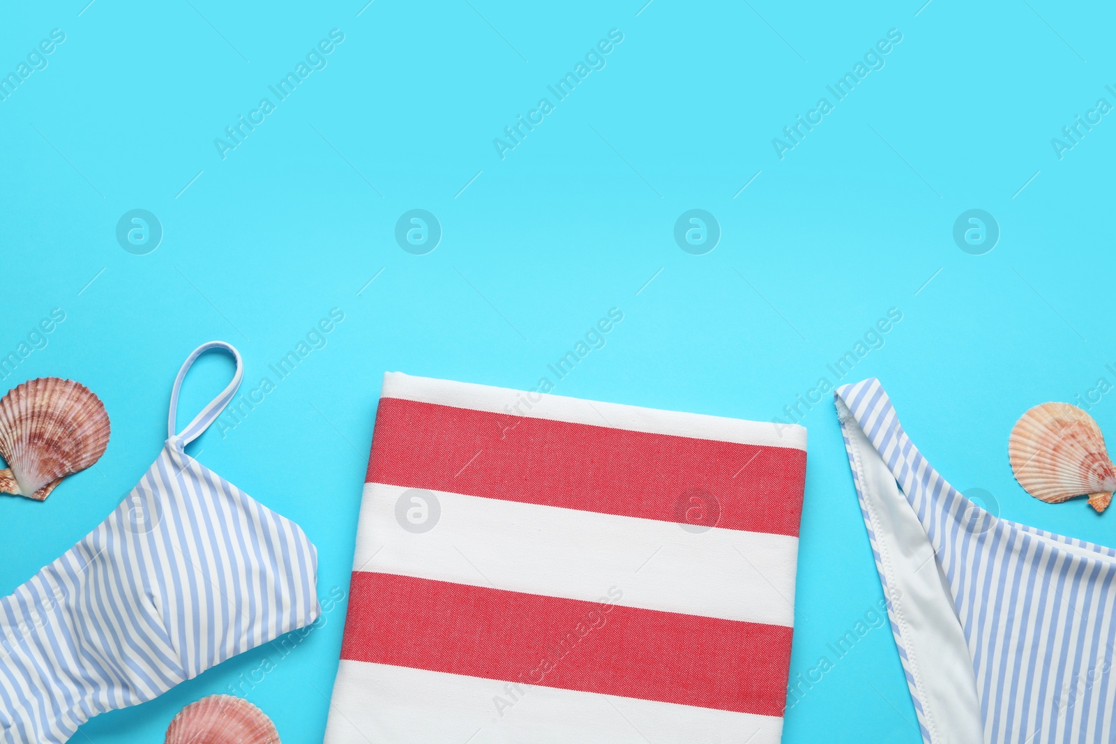 Photo of Flat lay composition with different beach objects on light blue background, space for text