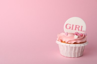 Photo of Baby shower cupcake with Girl topper on pink background, space for text