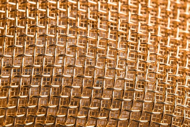 Photo of Metal mesh of microphone as background, closeup. Musical equipment