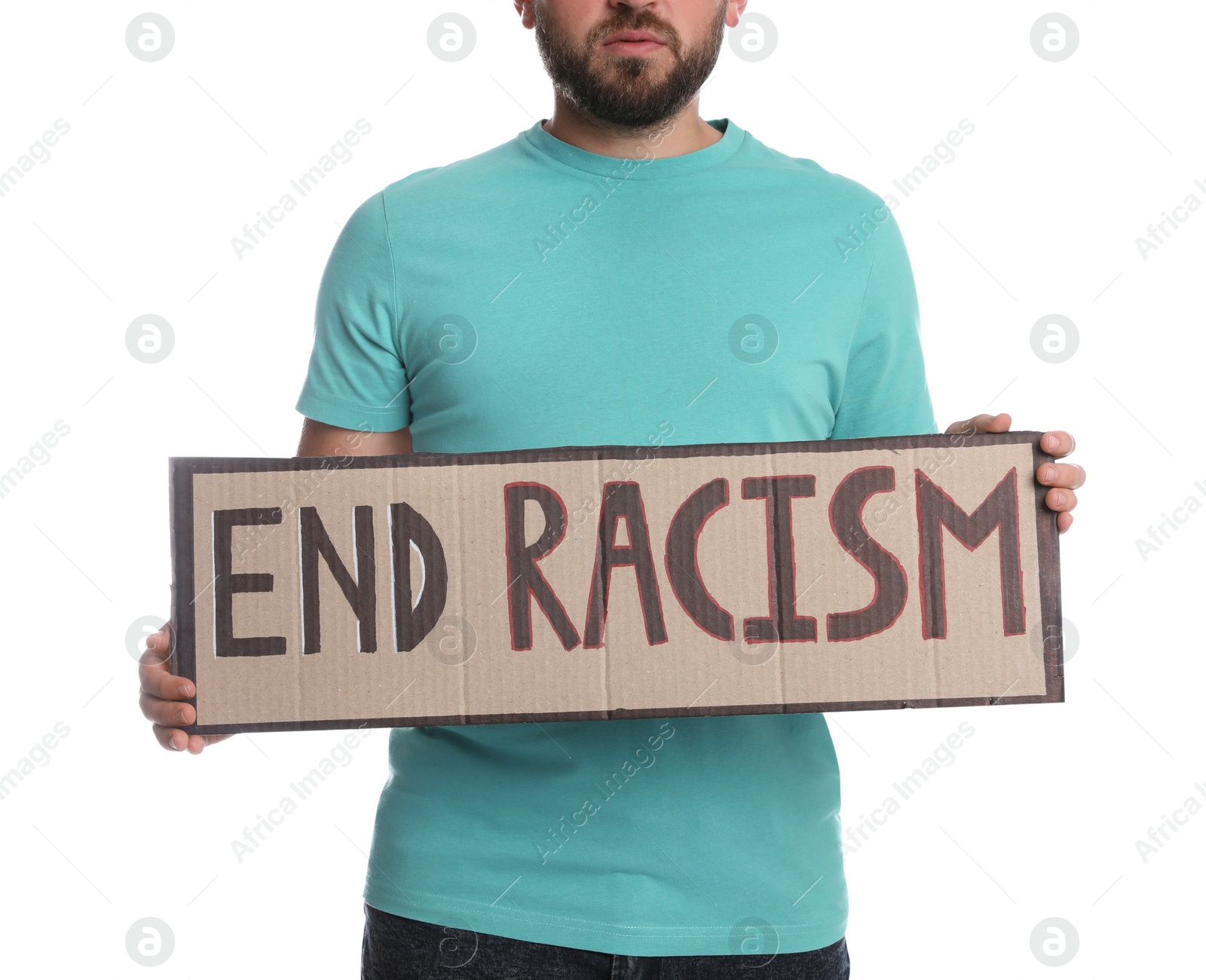 Photo of Young man holding sign with phrase End Racism on white background, closeup