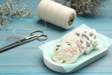 Photo of Tray with scented sachets on light blue wooden table 