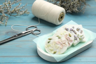 Tray with scented sachets on light blue wooden table 