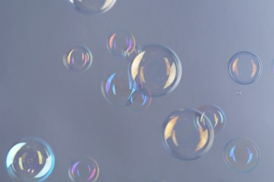 Beautiful transparent soap bubbles on gray background
