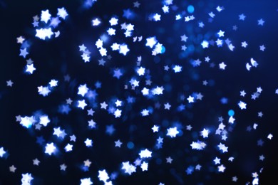 Image of Many beautiful shimmering stars and blurred lights on dark blue background. Bokeh effect