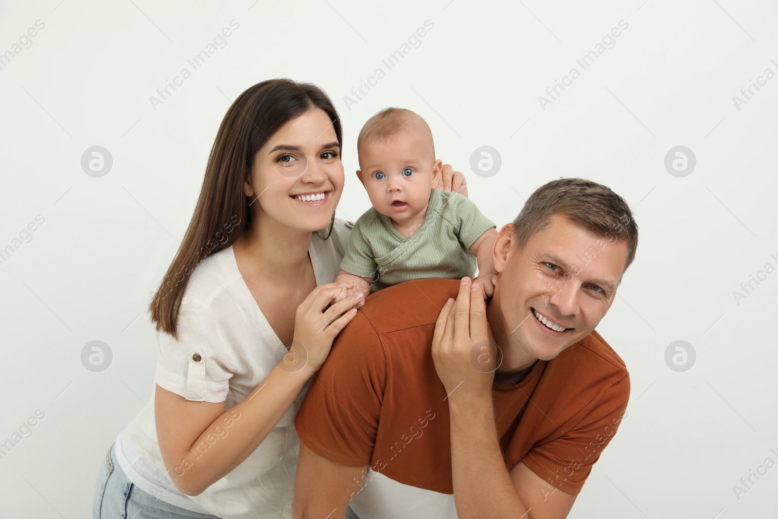 Photo of Portrait of happy family with their cute baby on white background