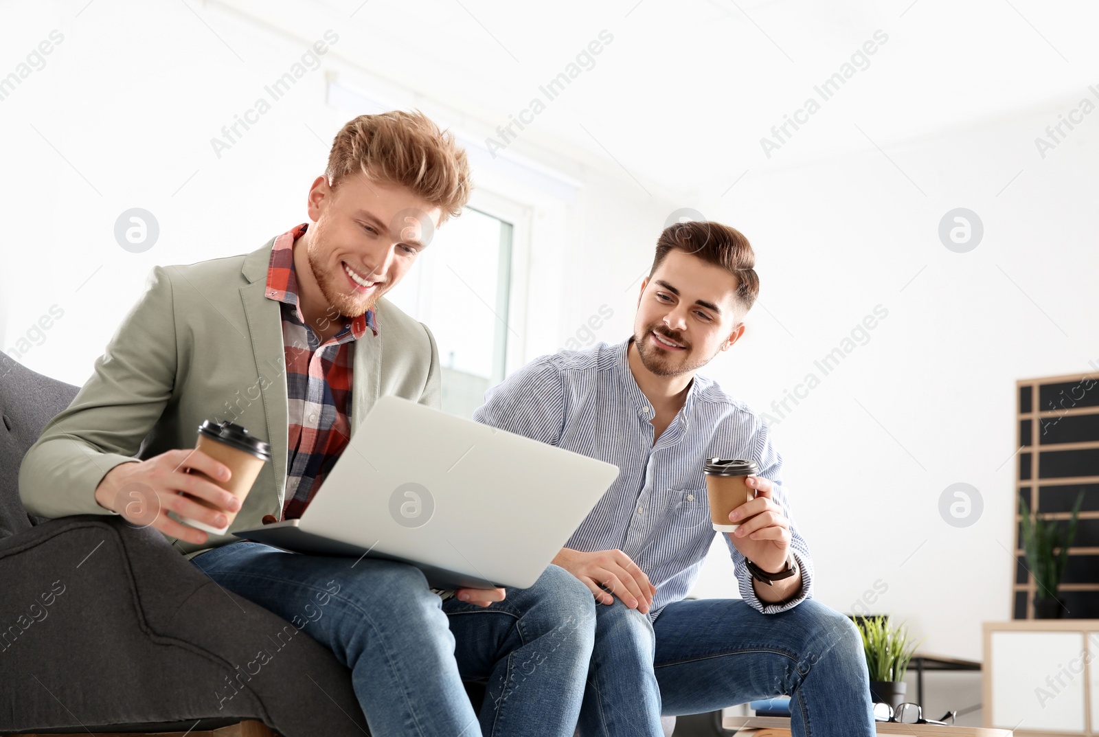 Photo of Business people working on laptop in office. Professional communication