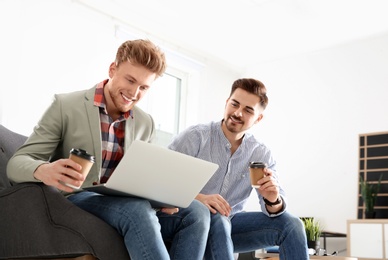 Photo of Business people working on laptop in office. Professional communication