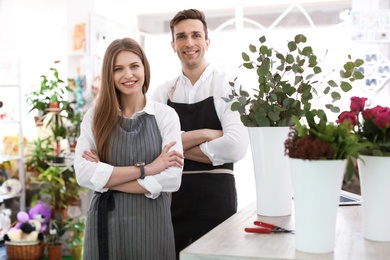 Male and female florists in flower shop