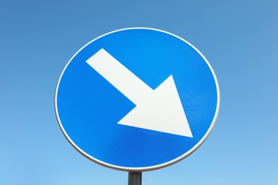 Traffic sign Keep Right against blue sky, low angle view