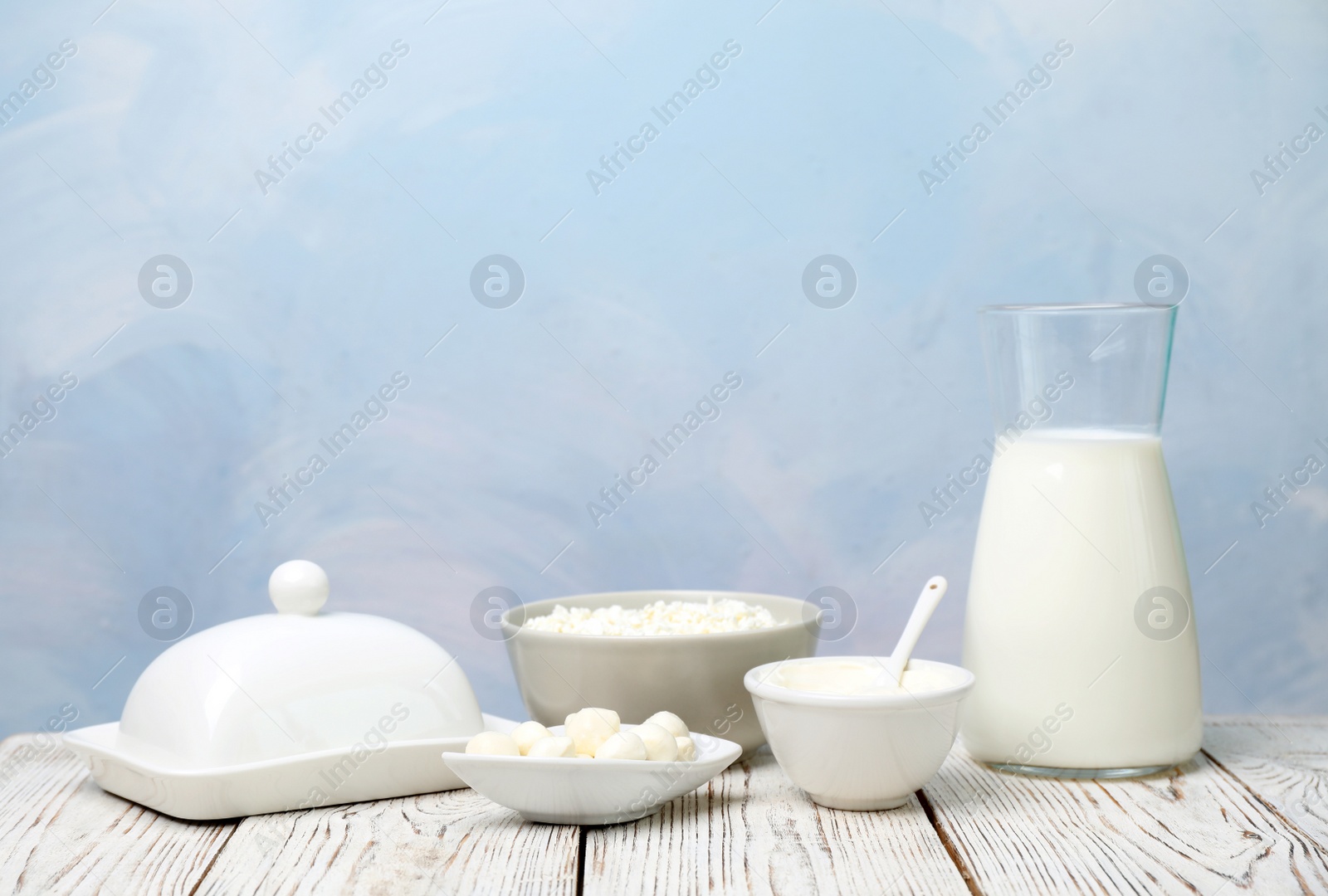 Photo of Different dairy products on wooden table