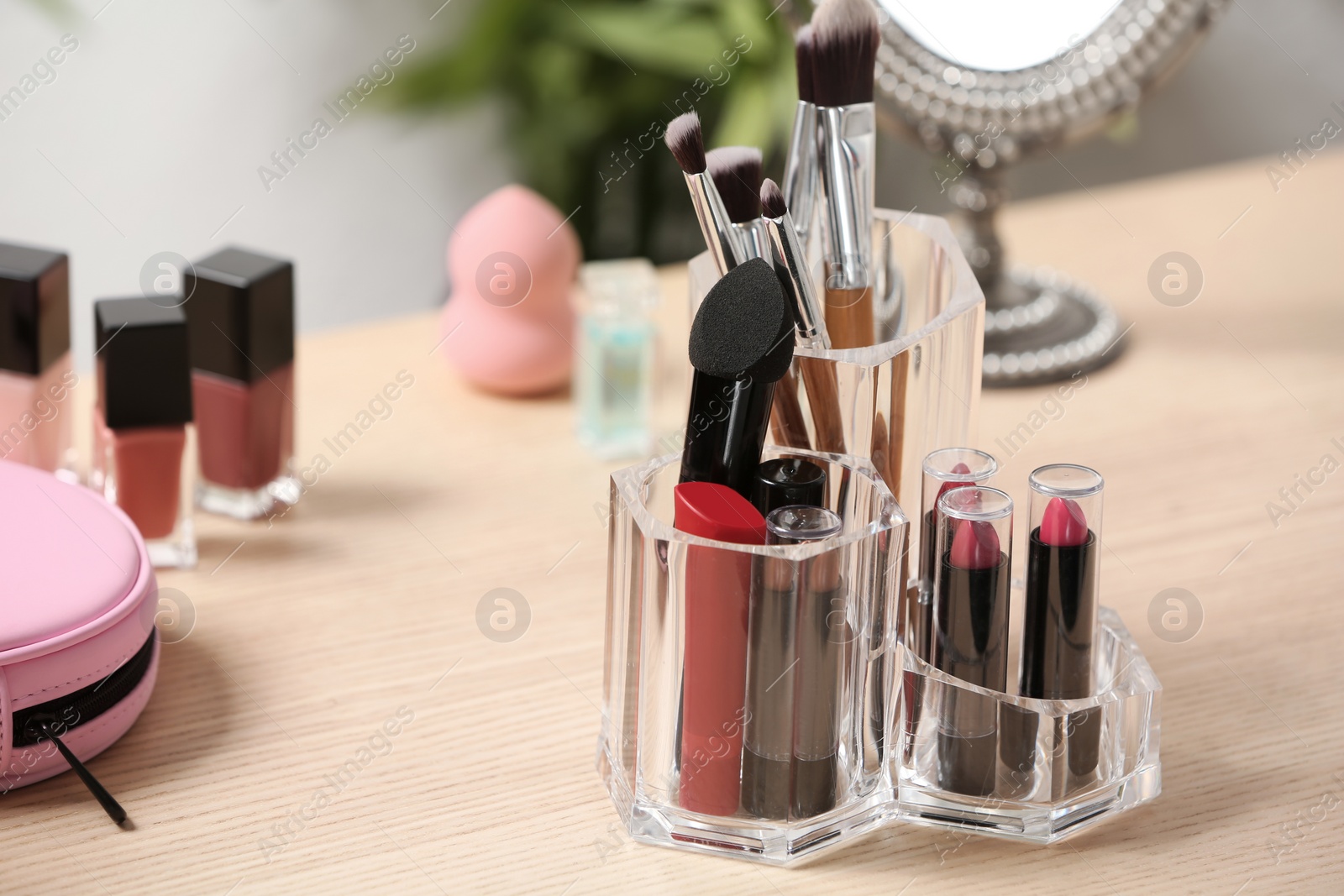 Photo of Set of decorative cosmetic products for makeup on dressing table. Space for text