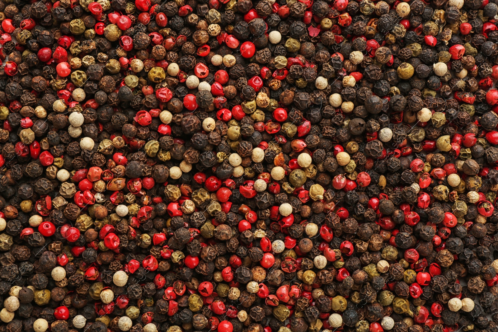 Photo of Different types of pepper as background. Natural spice