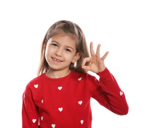 Photo of Little girl showing OK gesture in sign language on white background