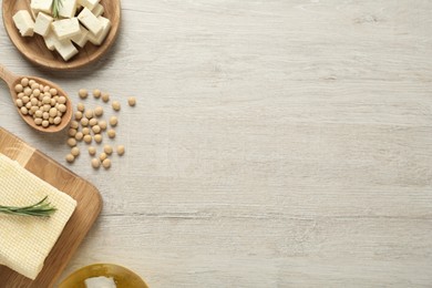 Photo of Pieces of delicious tofu with rosemary and soy on white table, flat lay. Space for text
