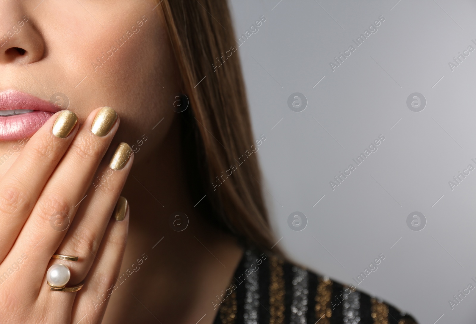 Photo of Beautiful woman with stylish nail polish on grey background, closeup. Space for text