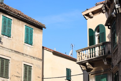 Exterior of old residential buildings against light blue sky