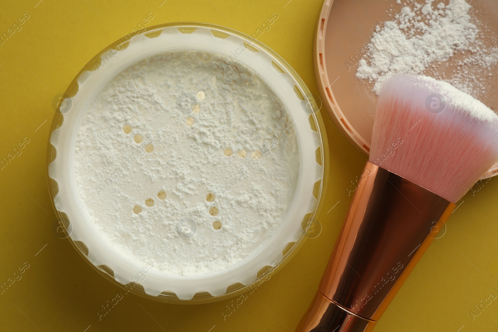 Photo of Rice loose face powder and makeup brush on yellow background, flat lay