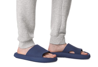 Photo of Man in blue slippers on white background, closeup