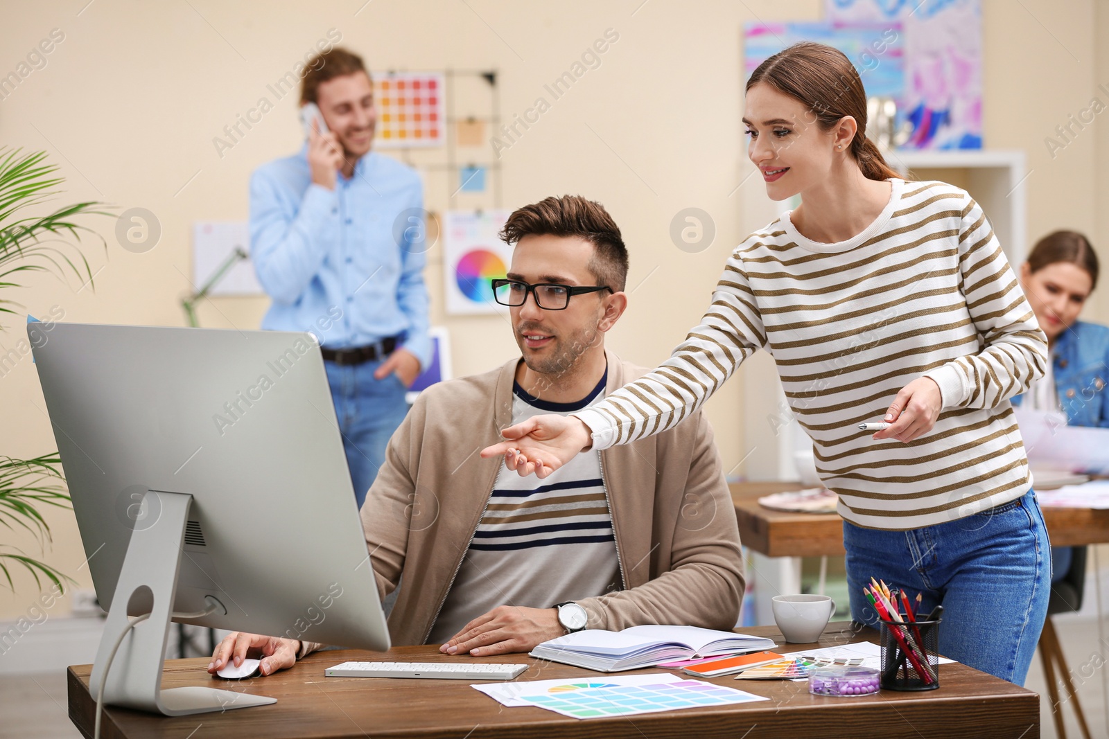 Photo of Professional interior designer with colleague working in office