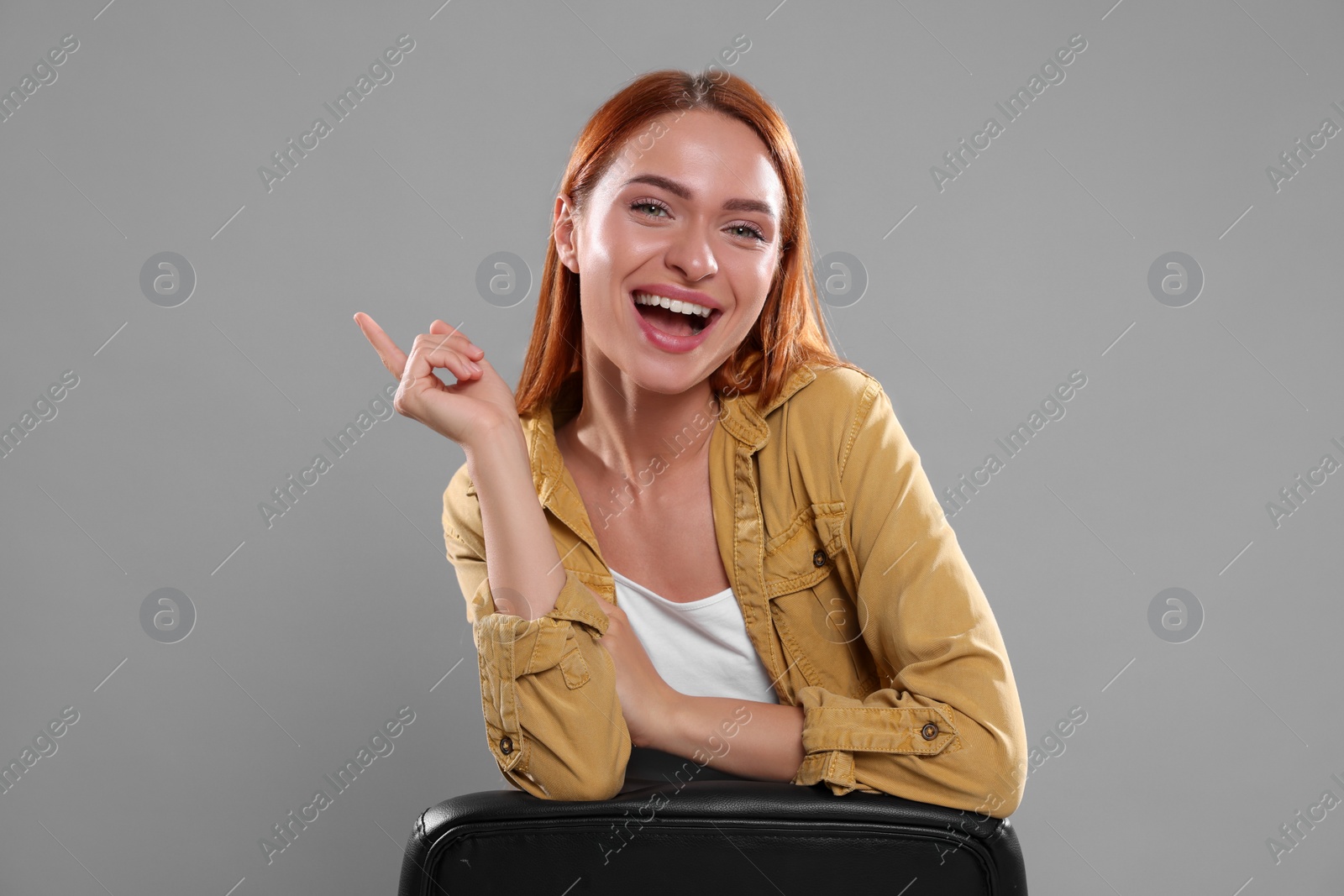 Photo of Casting call. Emotional woman performing on grey background