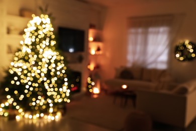 Photo of Blurred view of living room interior with decorated Christmas tree