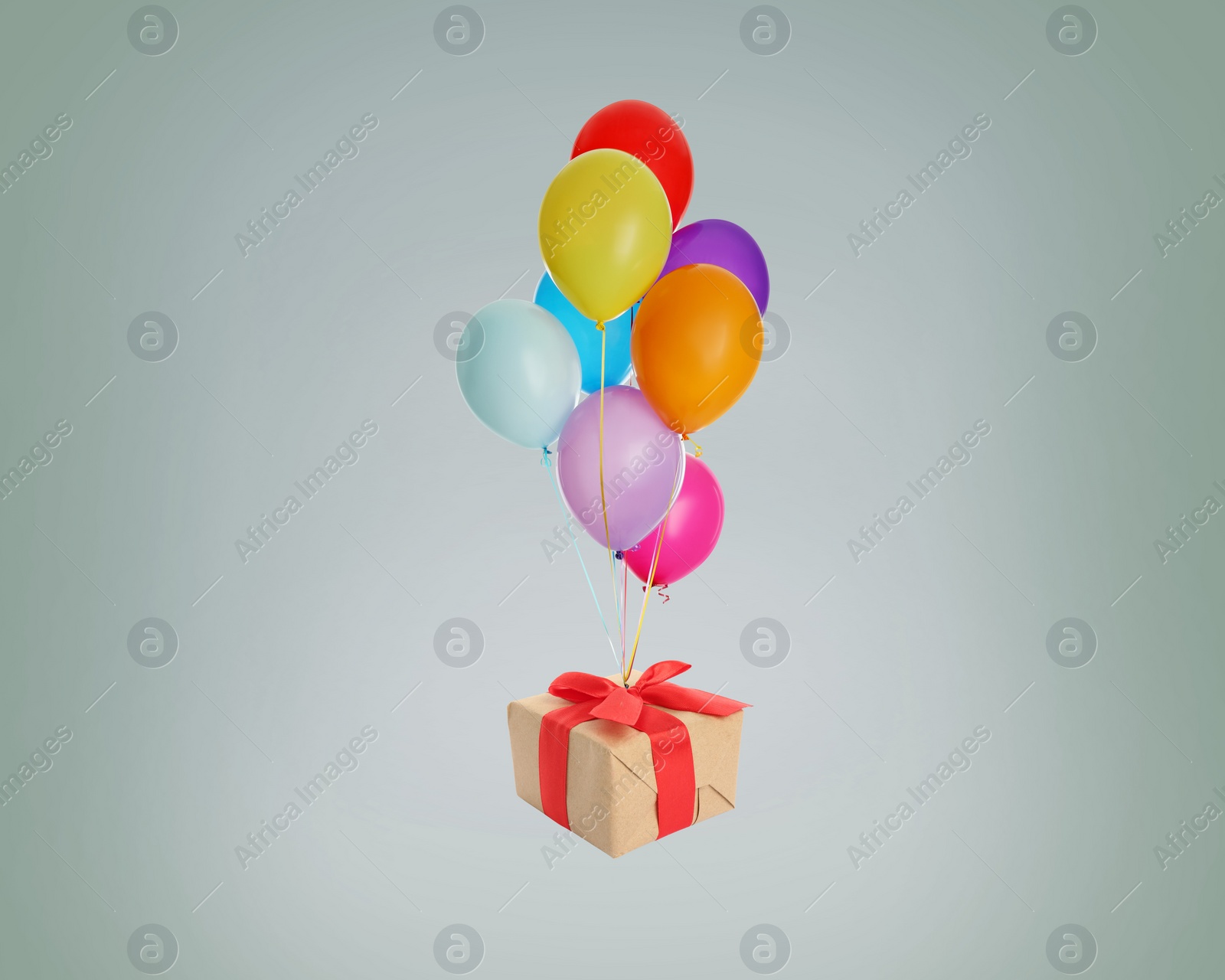 Image of Many balloons tied to gift box on grey background
