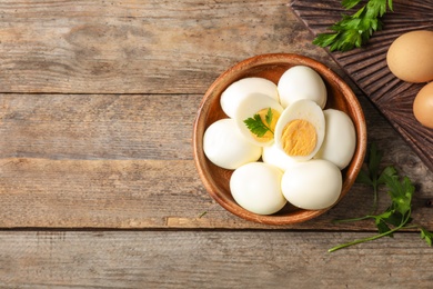 Photo of Flat lay composition with boiled eggs and space for text on wooden background