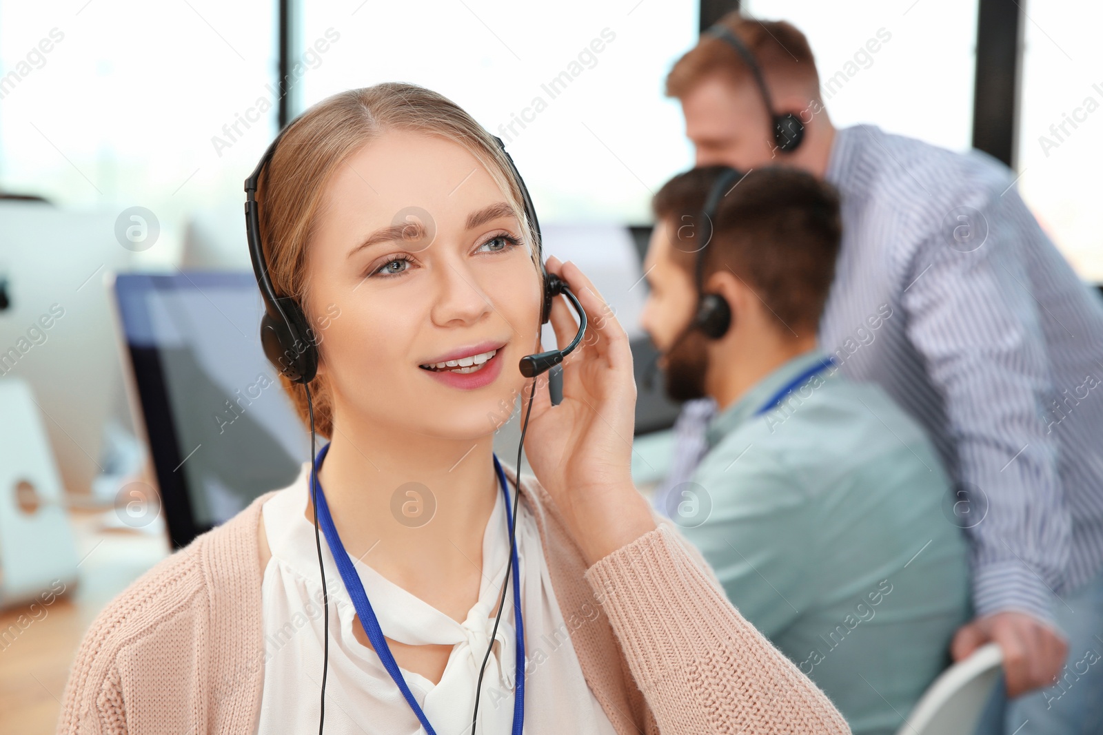 Photo of Technical support operator with colleagues in office