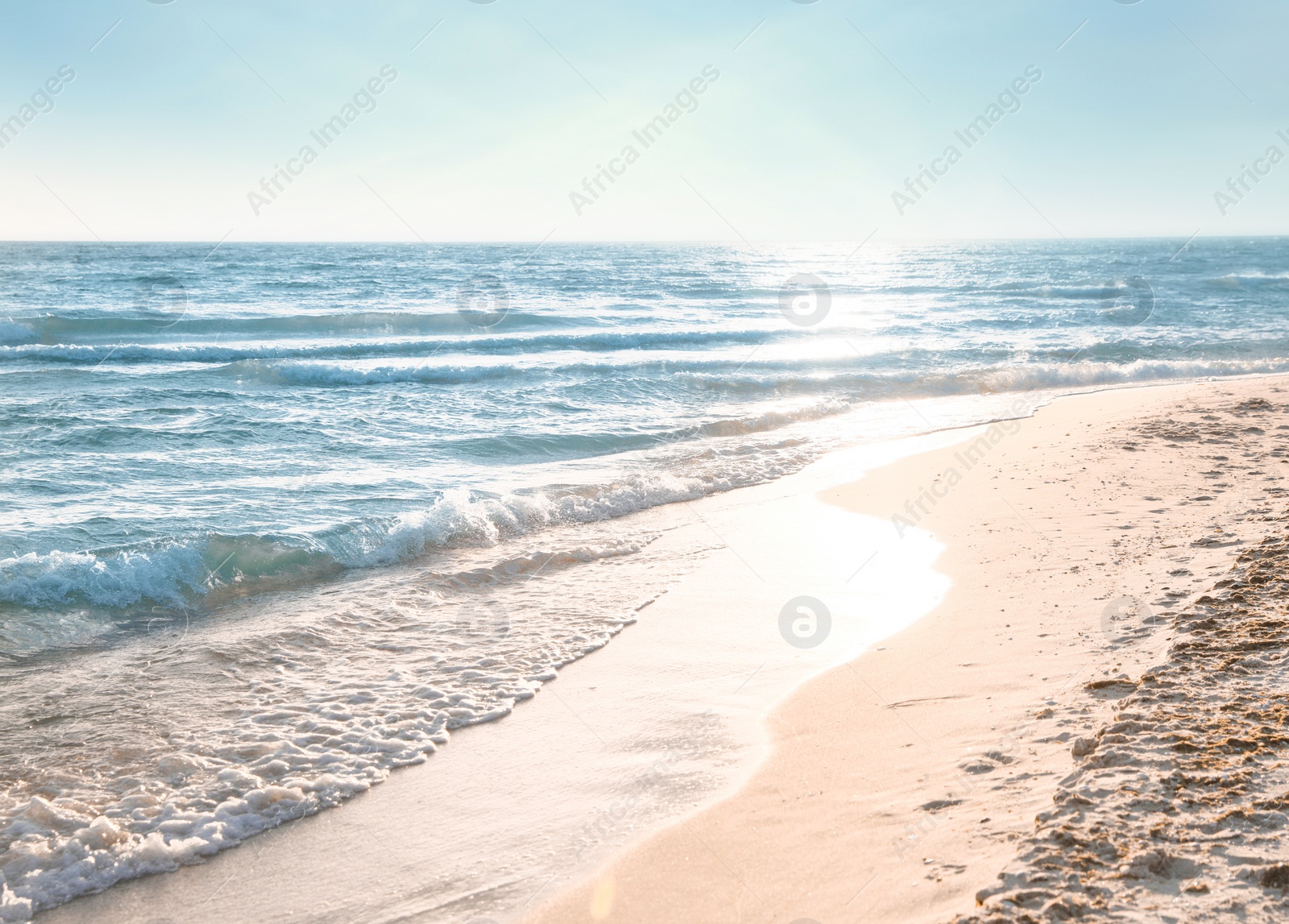 Photo of Sea waves rolling onto sandy tropical beach