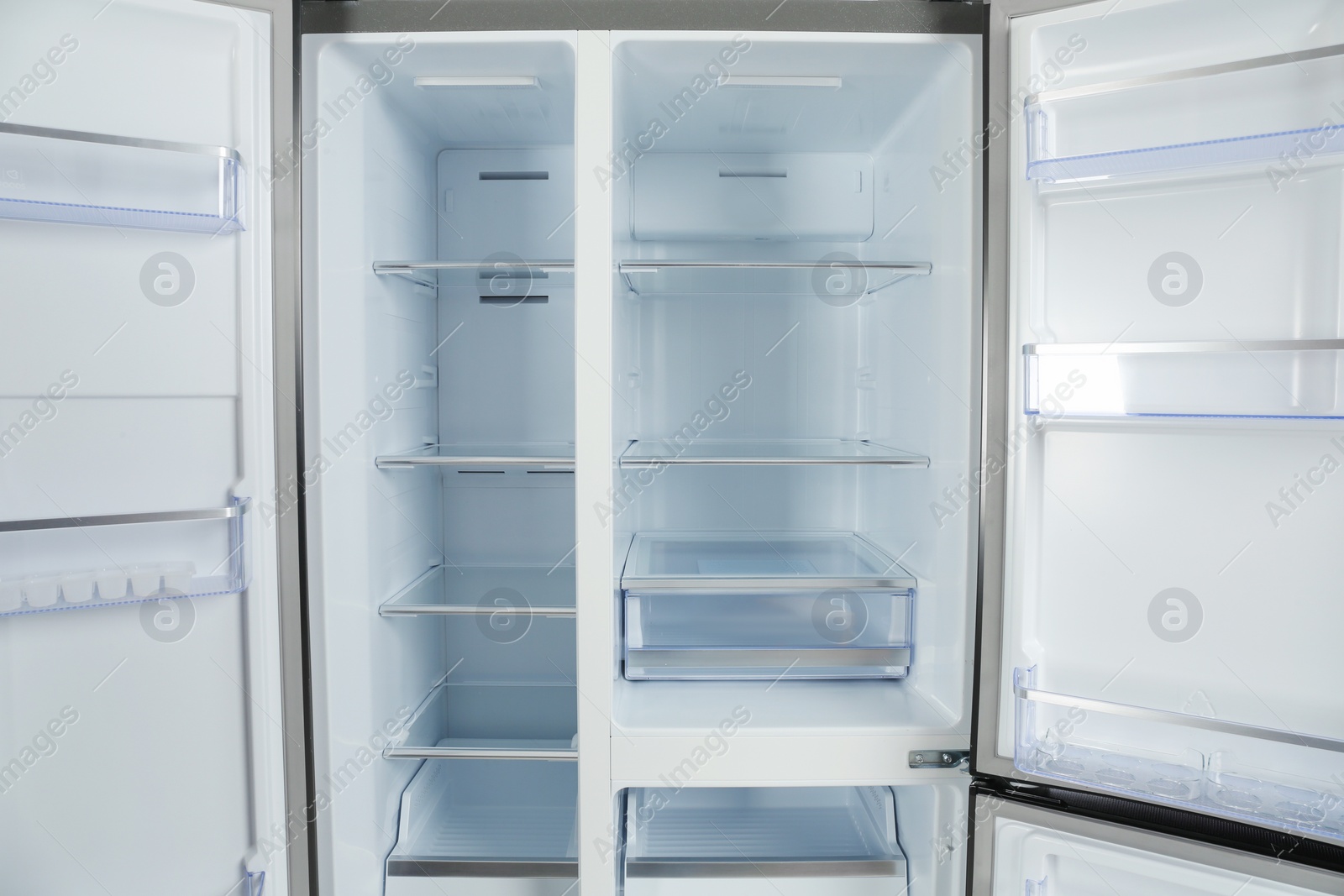 Photo of Shelves of empty modern refrigerator, closeup view