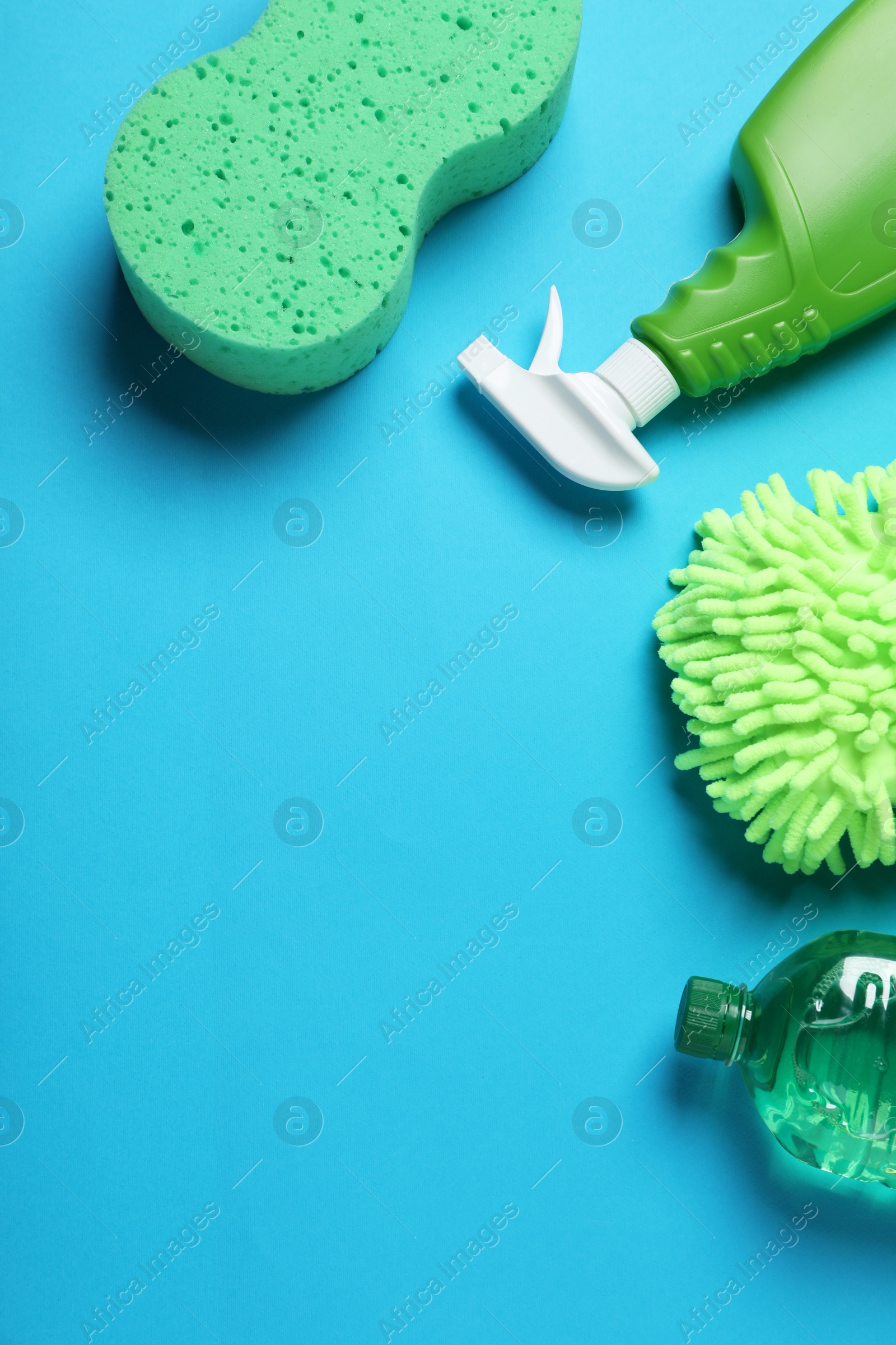 Photo of Different car wash products on light blue background, flat lay. Space for text