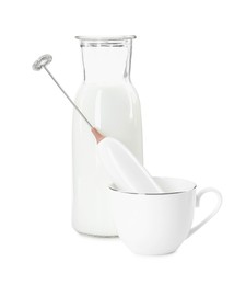 Photo of Milk frother wand, cup and glass carafe isolated on white
