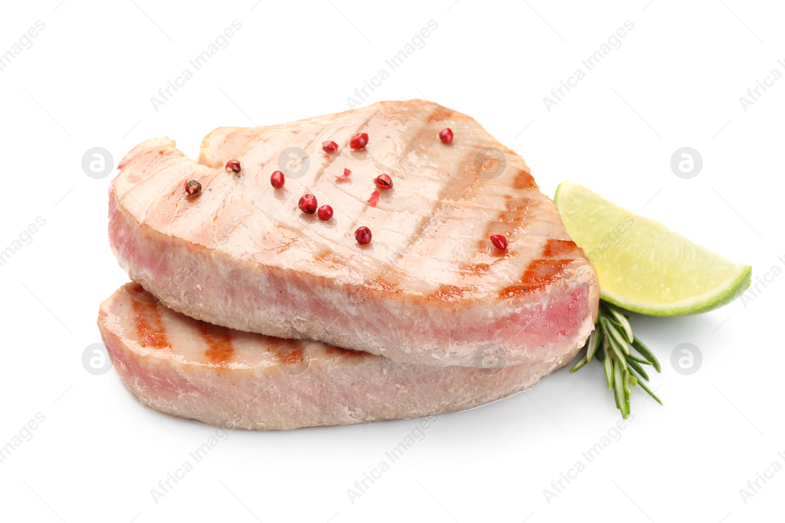 Photo of Delicious tuna steaks with spices, lime and rosemary isolated on white