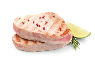 Delicious tuna steaks with spices, lime and rosemary isolated on white