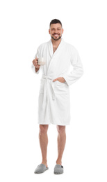 Photo of Handsome man in bathrobe with cup of coffee on white background
