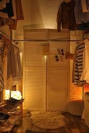 Photo of Modern dressing room with different stylish clothes and accessories