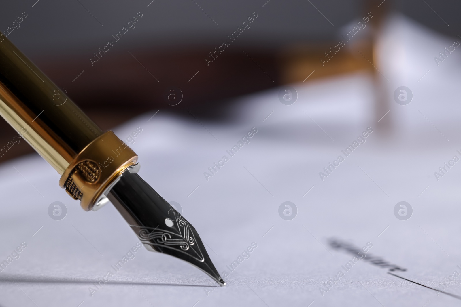 Photo of Writing on document with fountain pen, closeup and space for text. Notary contract