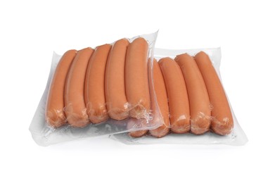 Photo of Packs of fresh raw sausages isolated on white. Ingredients for hot dogs