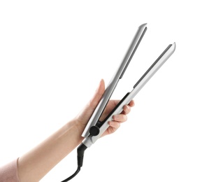 Woman holding hair iron against white background, closeup