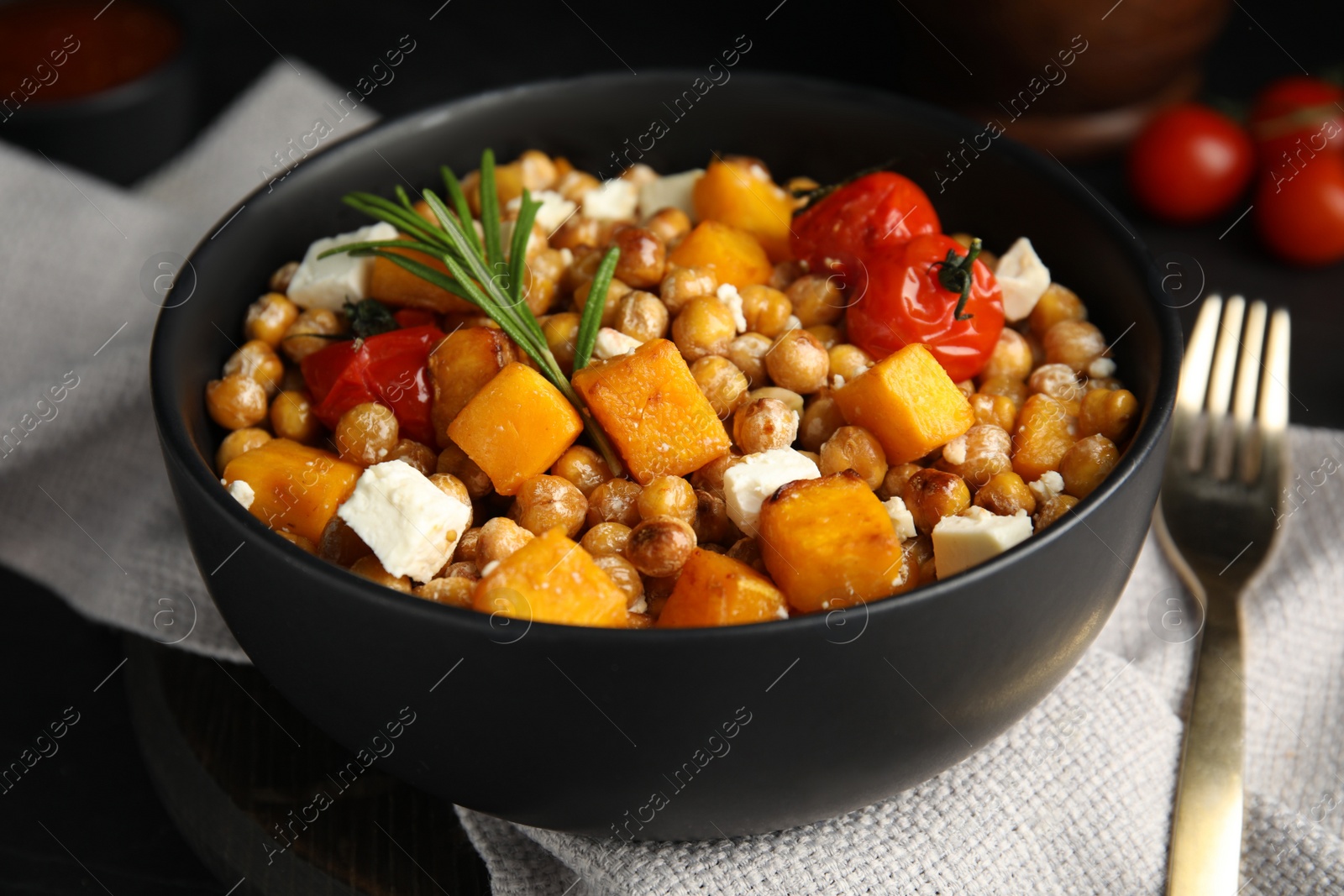 Photo of Delicious fresh chickpea salad on black table