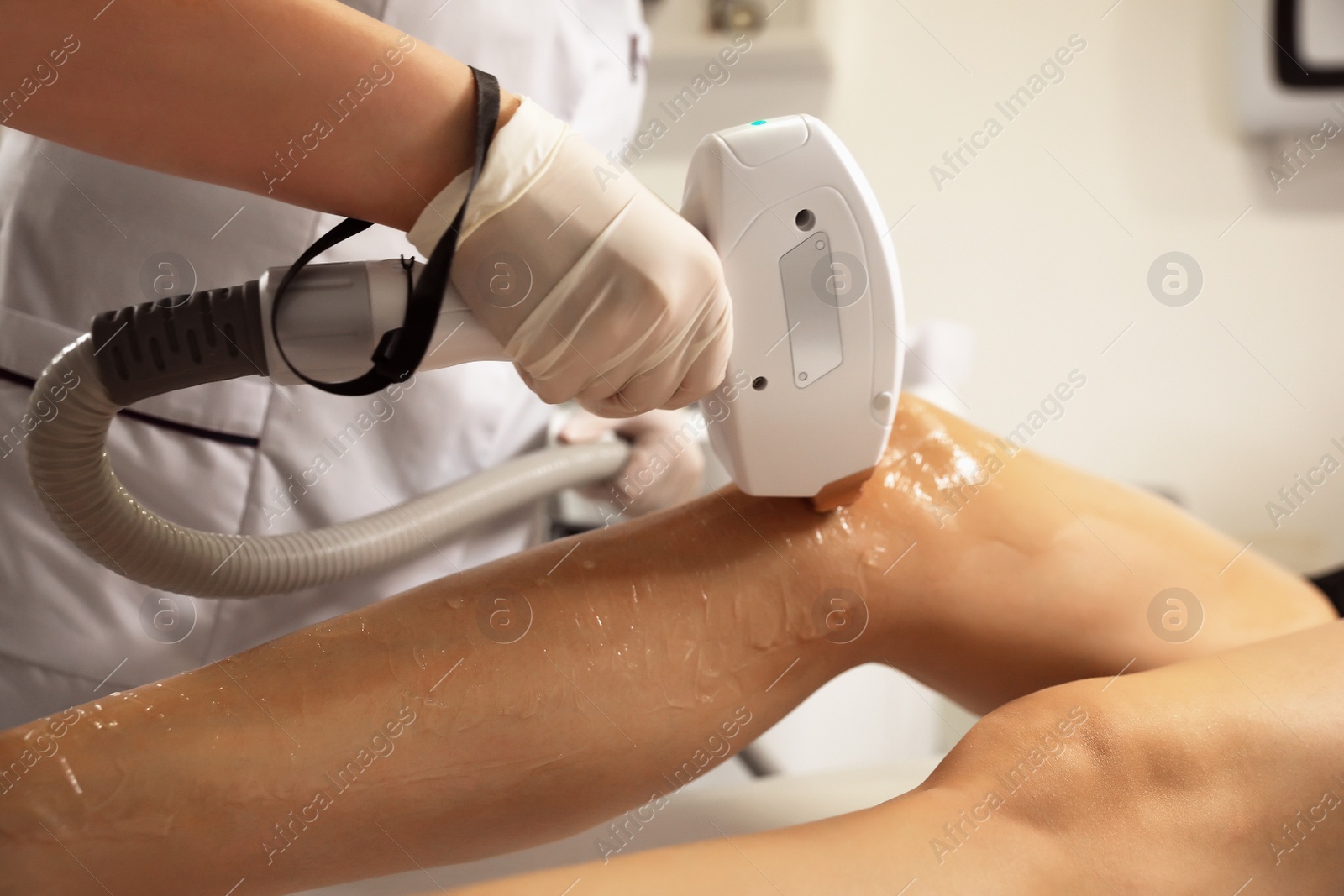 Photo of Woman undergoing laser epilation procedure in beauty salon, closeup