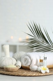 Photo of Composition with different spa products and plumeria flower on white table indoors