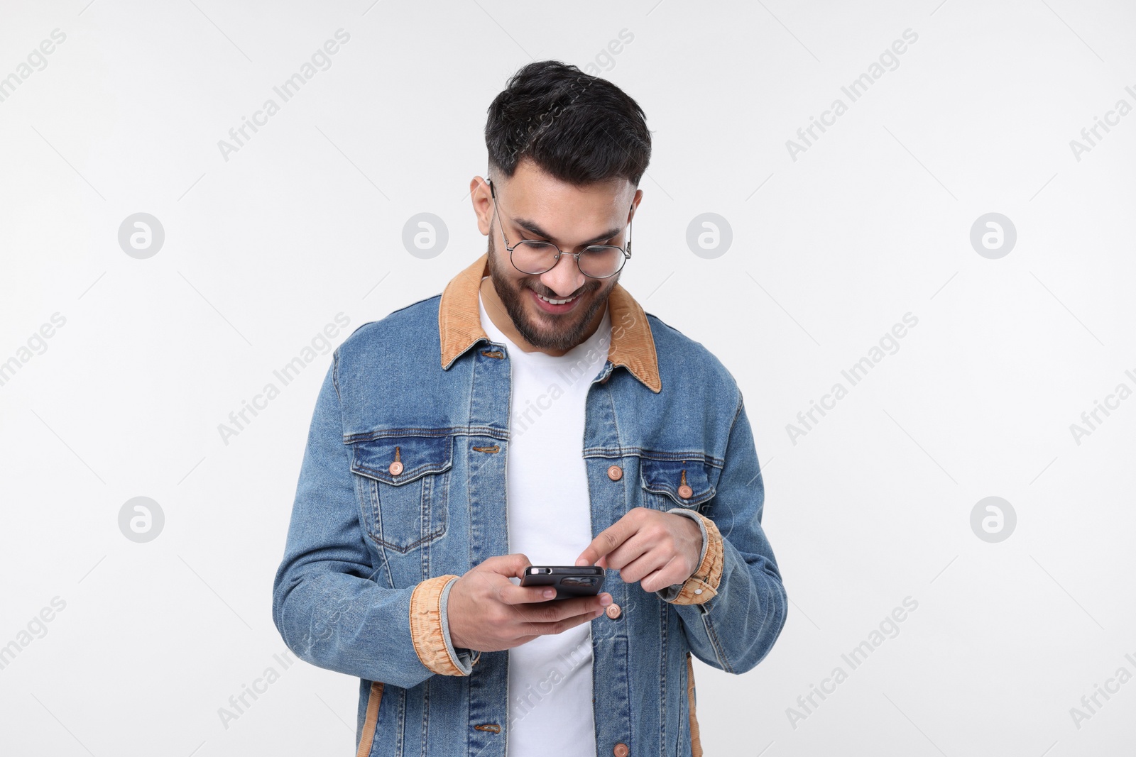 Photo of Happy man using smartphone on white background