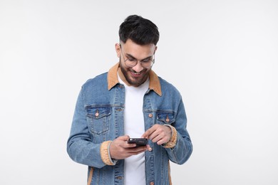 Photo of Happy man using smartphone on white background