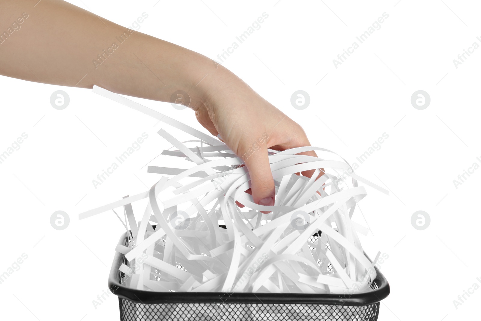 Photo of Woman taking shredded paper strips into trash bin on white background, closeup