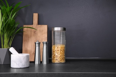 Composition with kitchenware on table against grey background. Space for text